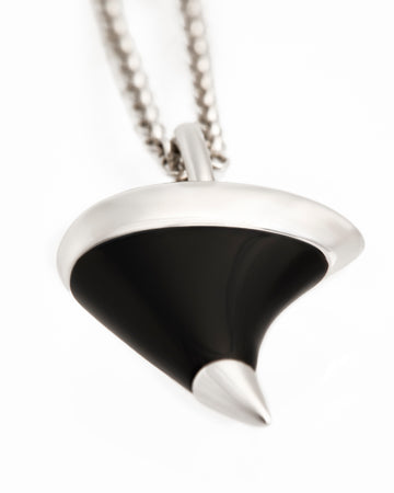 Black and silver pendant necklace on a white background