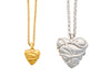 Gold and silver heart-shaped pendants on white background