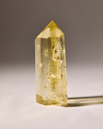 Clear crystal with yellow tint on a gray background