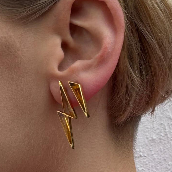 ear with 2 earrings in using the gemstone Citrine. The first earring is a full lightning Bolt shape and the 2nd earring is a half bolt (spark). Crafted from 18ct Gold Vermeil and Citrine.