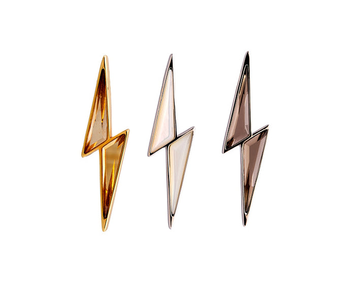 Three gold lightning bolt-shaped earrings on a white background