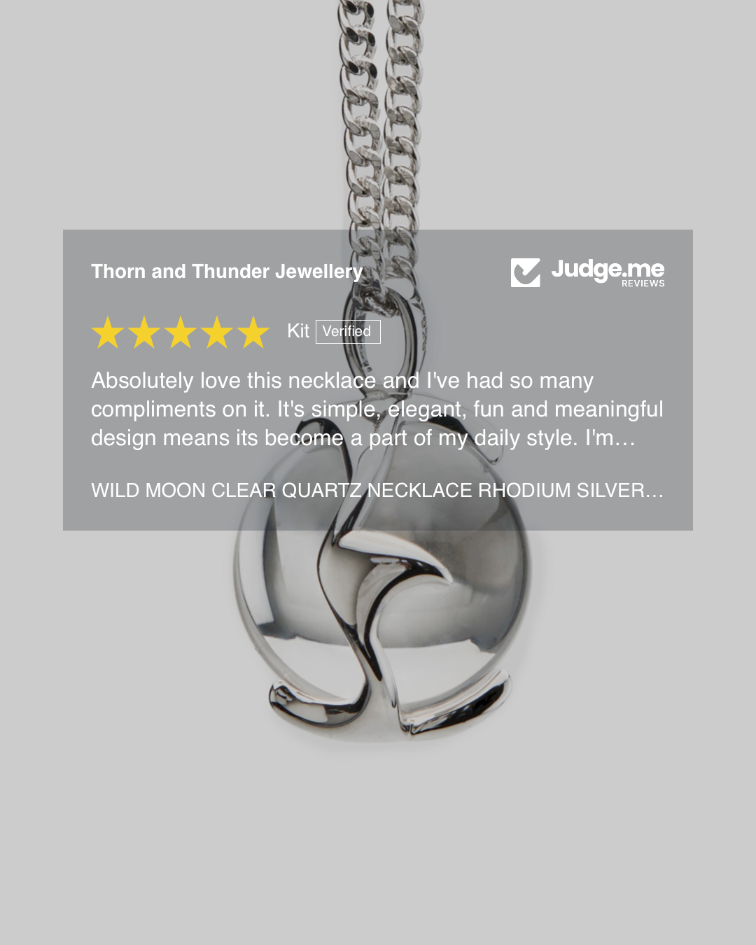 Silver necklace with clear quartz stones on a gray background, featuring a 5-star rating and review.