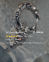 Silver hoop earring with heart charm on a textured surface, surrounded by product reviews.