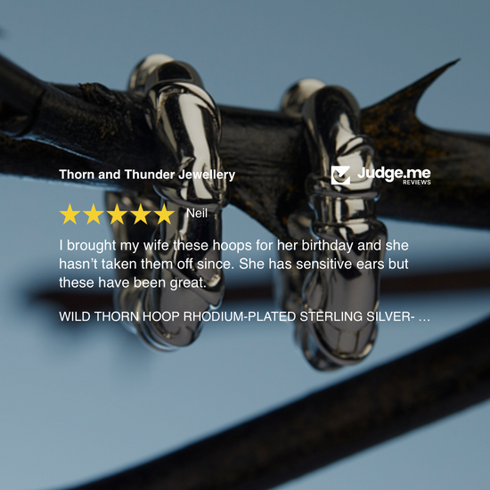 Pair of wild thorn hoop earrings with a five-star rating on a blue background